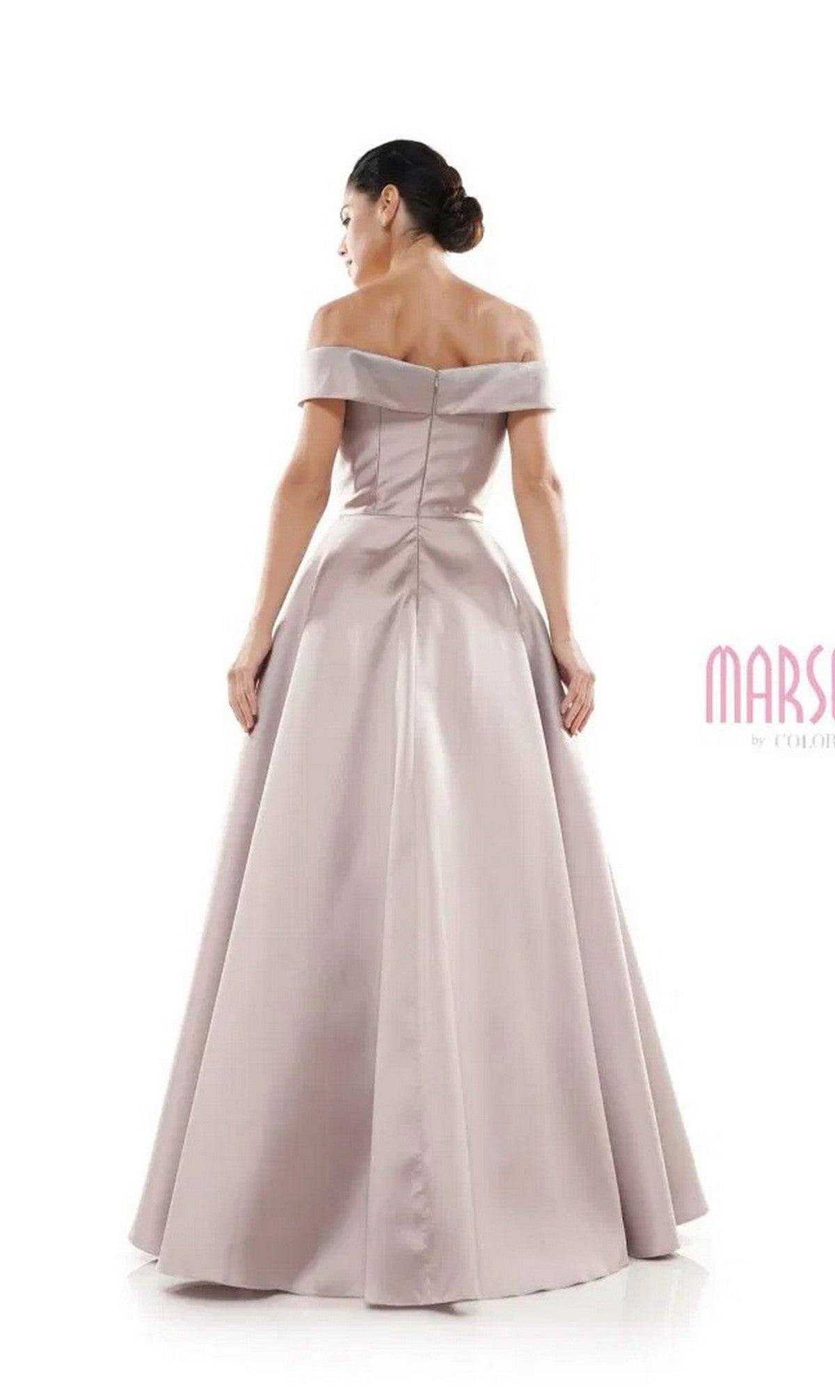 A woman is seen from the back wearing the Marsoni MV1008, a light mauve, floor-length A-line formal dress with off-the-shoulder design and delicate beaded applique, set against a white background.